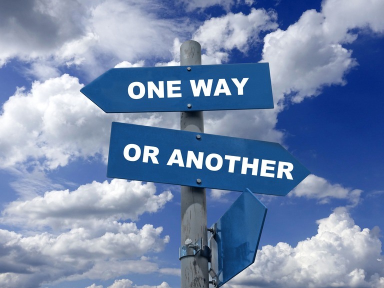 Directional sign showing choices in a cloudy sky, highlighting overlooked coaching chances for sales managers.