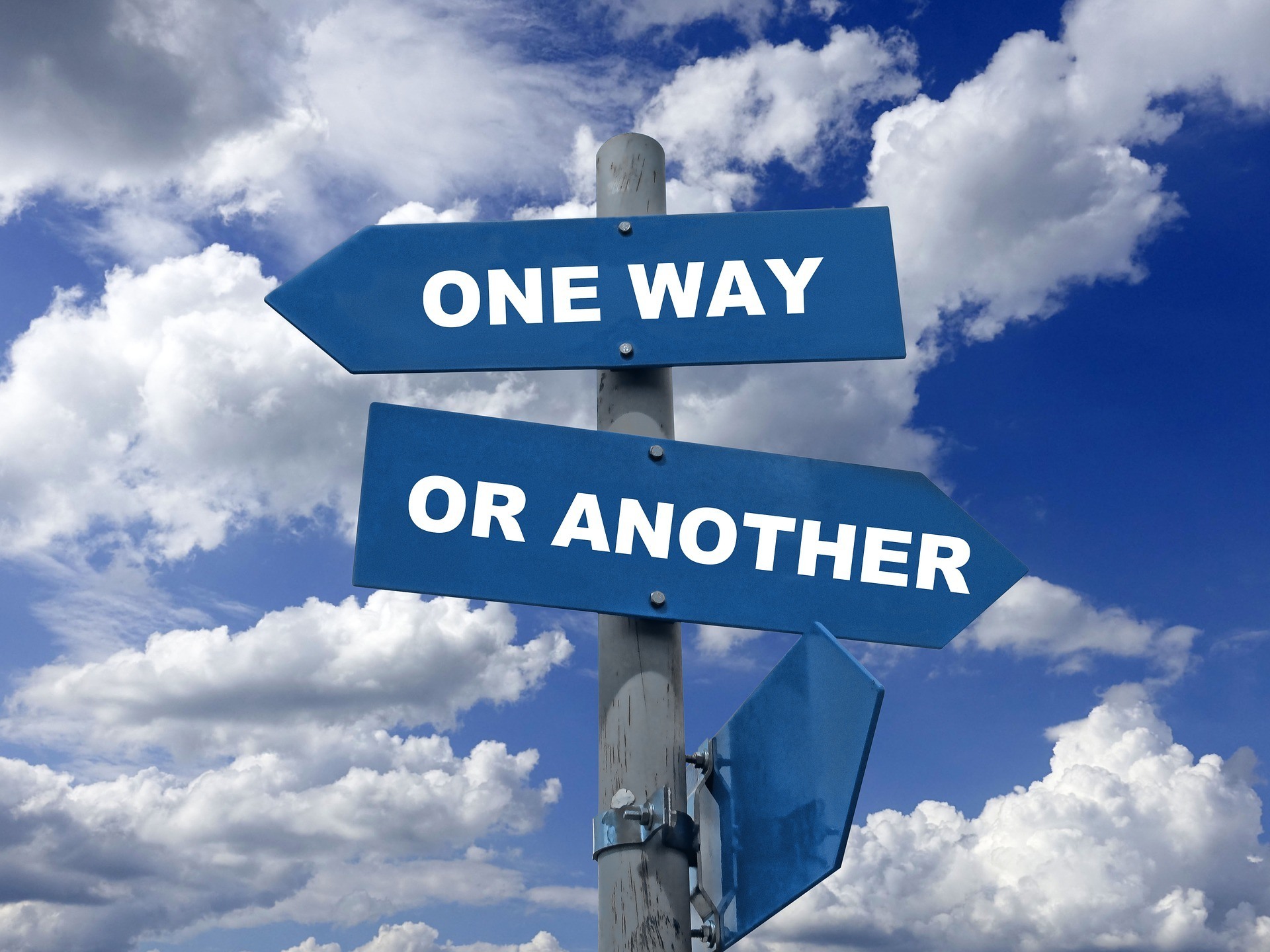 Directional sign showing choices in a cloudy sky, highlighting overlooked coaching chances for sales managers.