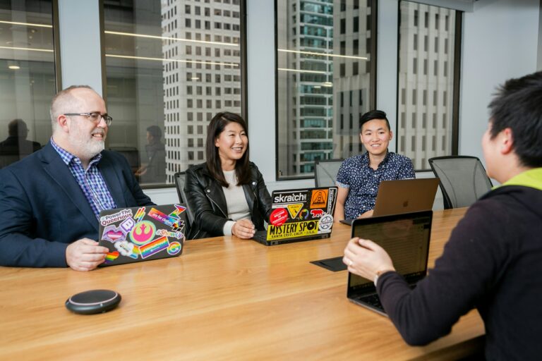 Sales leaders in a boardroom discussion, collaborating to lead teams in today’s fast-changing business world.