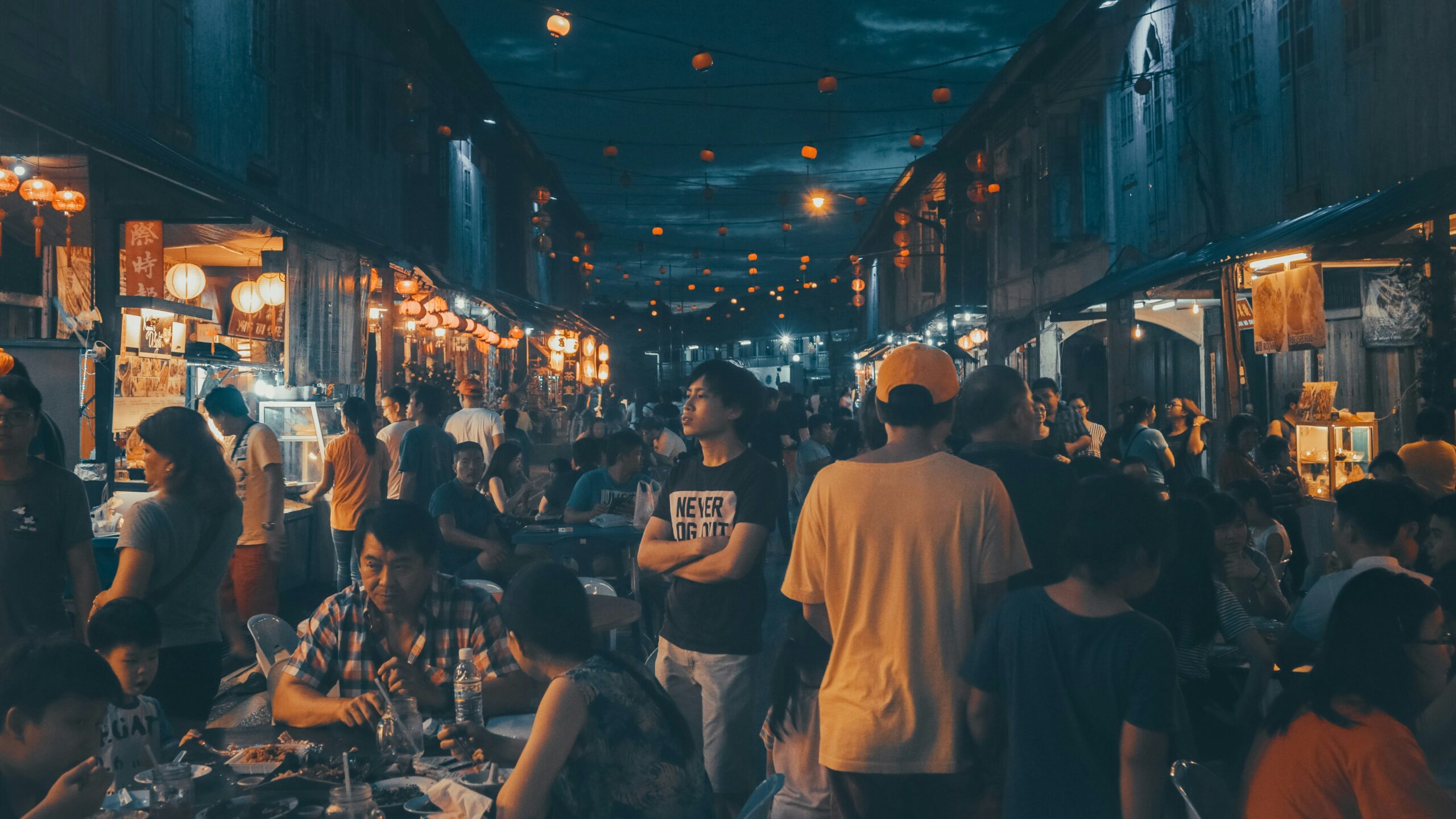 Crowded Malaysian night market, representing evolving consumer trends in the local food service scene.