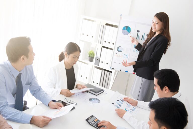 Sales team discussing plans in a meeting room, highlighting strategy alignment and business growth.