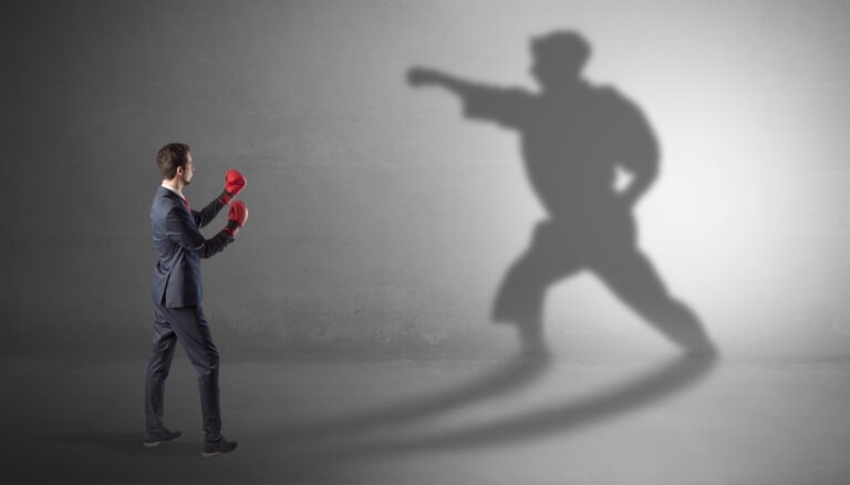 Coach observing a leader’s shadow in action, representing real-time performance feedback and growth.
