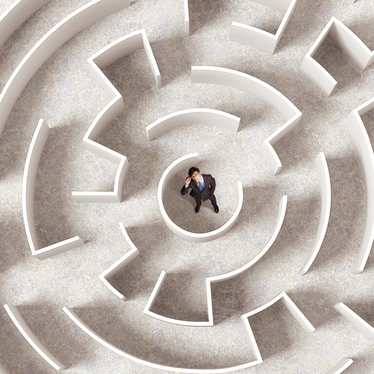 Top-down view of a person standing in a maze, symbolising decision-making challenges in uncertain leadership environments.