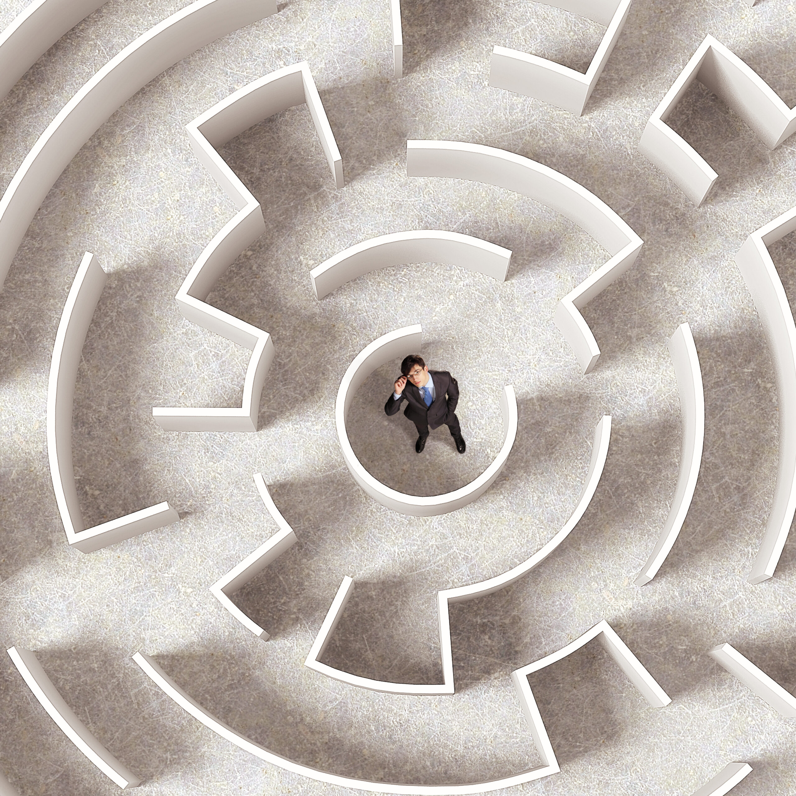 Top-down view of a person standing in a maze, symbolising decision-making challenges in uncertain leadership environments.