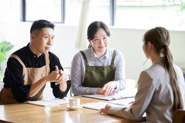 Food service Sales Professional coaching restaurant owners on menu planning and business improvement during a client meeting.